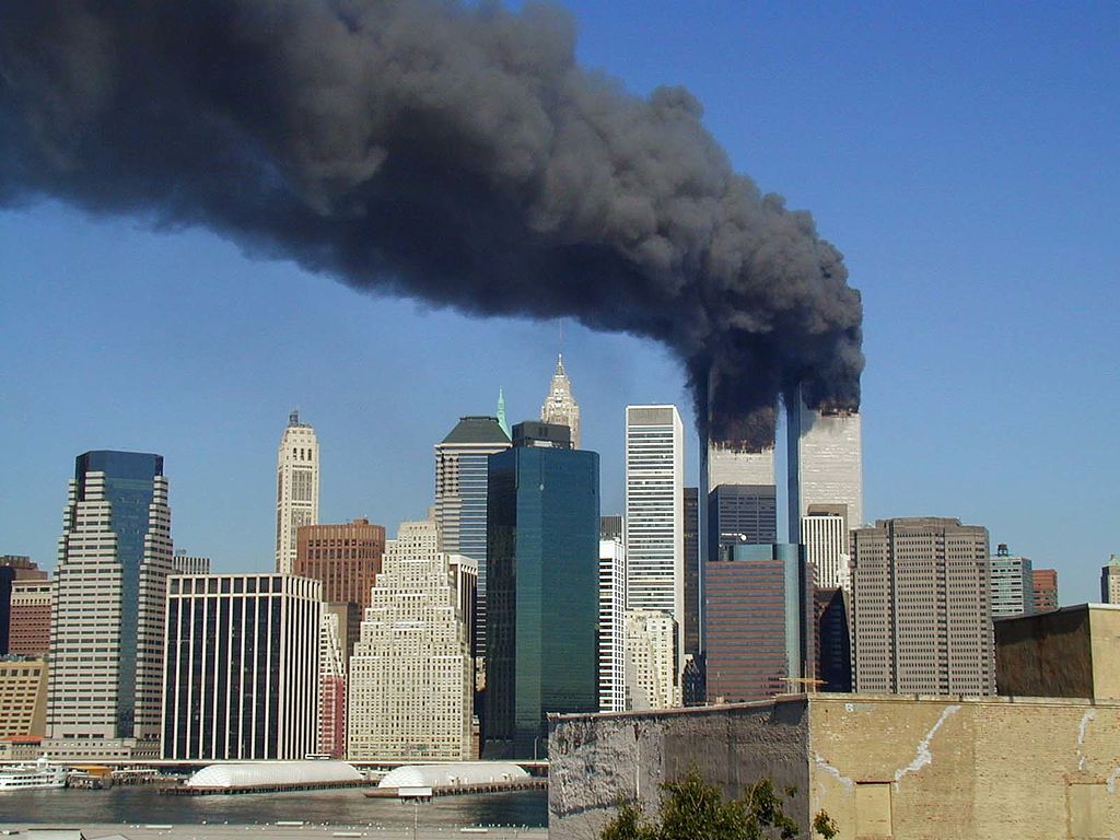 "Plumes of smoke billow from the World Trade Center towers in Lower Manhattan, New York City, after a Boeing 767 hits each tower during the September 11 attacks." by Michael Foran is licensed under CC BY 2.0