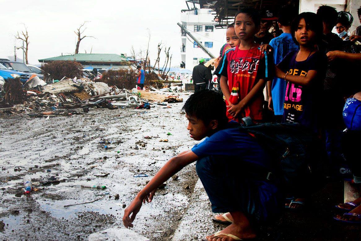 A child looks as if he is pondering what the future holds in this photo taken at the Daniel Z. Romualdez Airport in Tacloban City a week after Yolanda left a trail of destruction in the Philippines. | Photo by Julius D. Mariveles