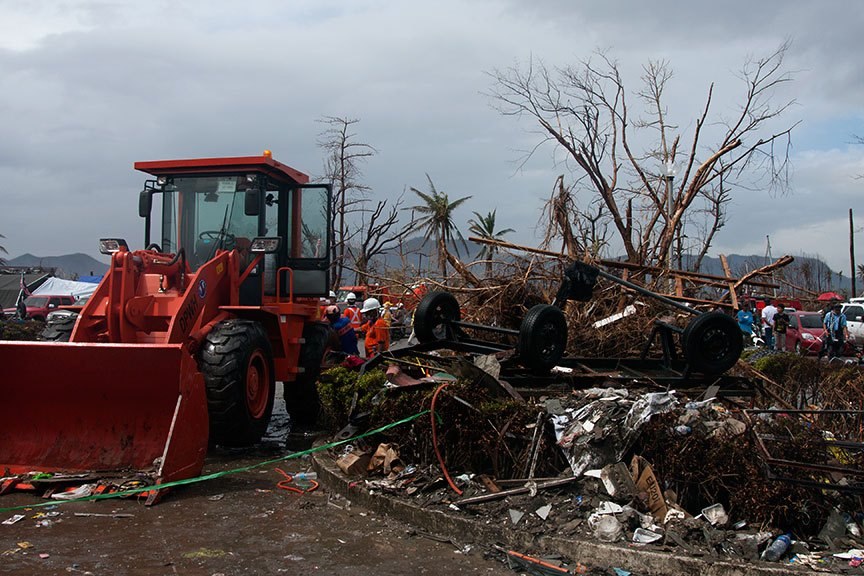 DEBRIS, LOTS OF DEBRIS. Lots of loading and disposing was one of the urgent tasks in Tacloban City, as shown in this photo taken a week after the superstorm struck the country. Tacloban was among the hardest hit areas in the Visayas. | Photo by Julius D. Mariveles