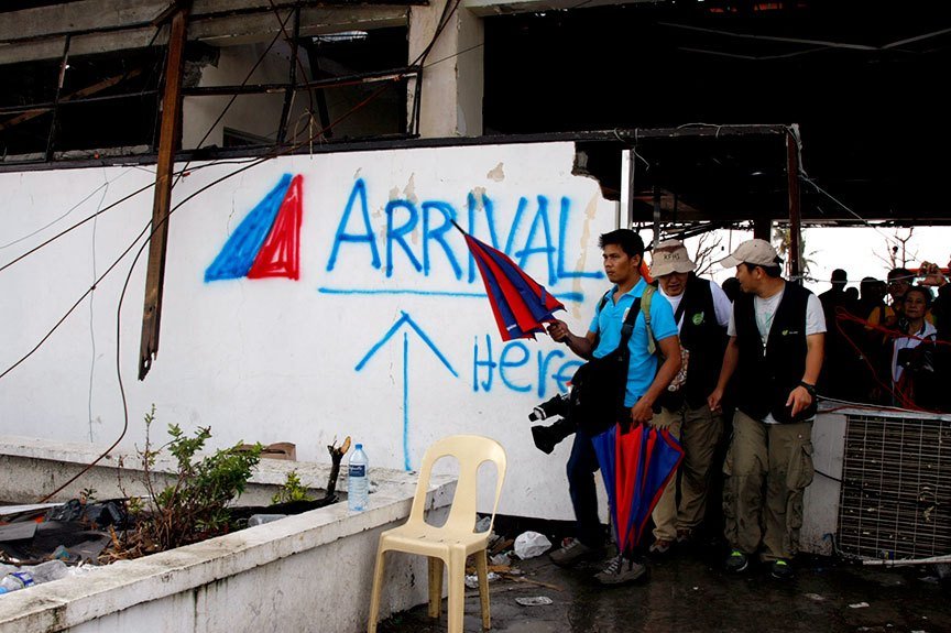 The remains of the arrival area of the Daniel Z. Romualdez Airport in Tacloban City looks like a grafitti wall a week after the superstorm, Yolanda (international codename Ruby) struck the Philippines, displacing at least a million in the Visayas group of islands alone. Close to 7,000 are believed to have been killed, according to government estimates. | Photo by Julius D. Mariveles