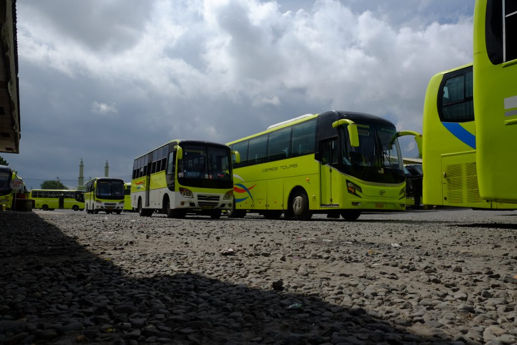Under dark skies. Employees walk past parked buses of the Ceres bus lines at the southern terminal owned by the firm in Bacolod City. | Photo by Jose Aaron C. Abinosa