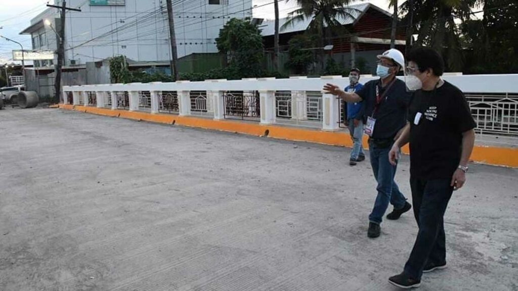 Mayor Evelio Leonardia and City Engineer Aladino Agbones inspect the newly replaced and widened bridge at Lacson Street Extension in October. The mayor will inaugurate the project tomorrow [Dec. 8].*/CITY PIO