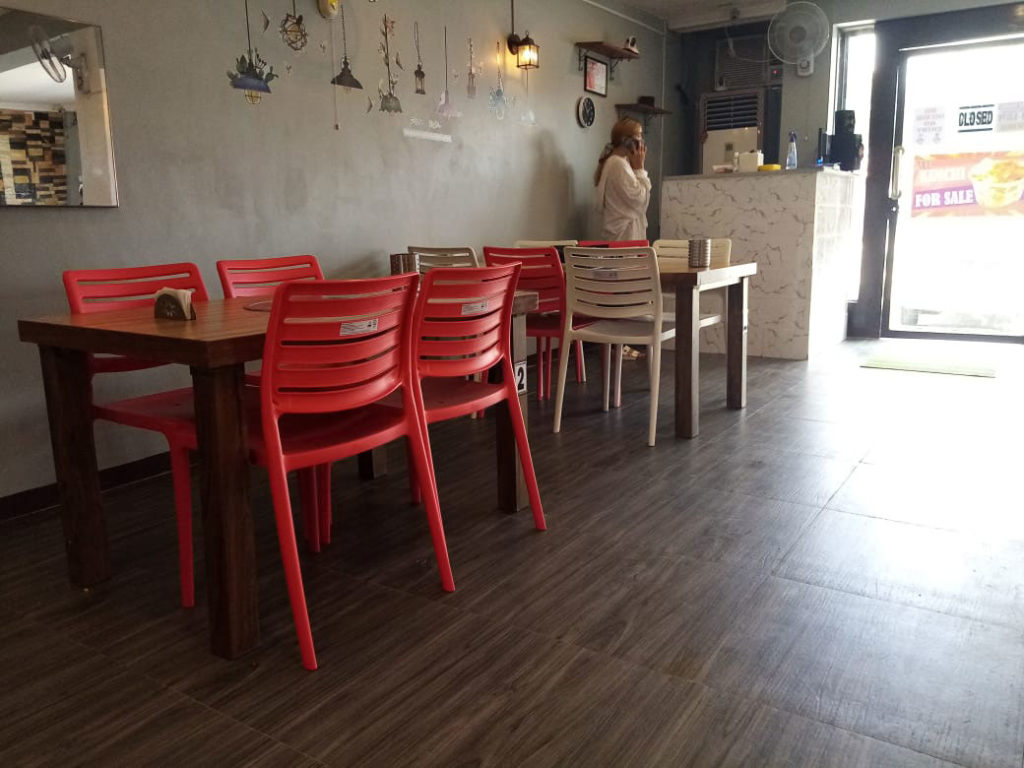 Sturdy plastic chairs in red are utilitarian and give a splash of color but provide more stability to patrons who are sure to add a pound or two after an all you can eat meal.