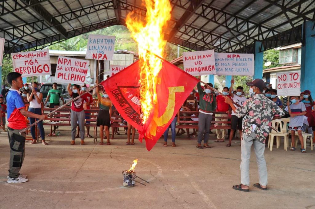 Residents of Sagay City and Toboso town burn flags of the Communist Party of the Philippines during an activity facilitated by the 79th Infantry Battalion to boost its counterinsurgency drive. | Photo by 79th Infantry Battalion