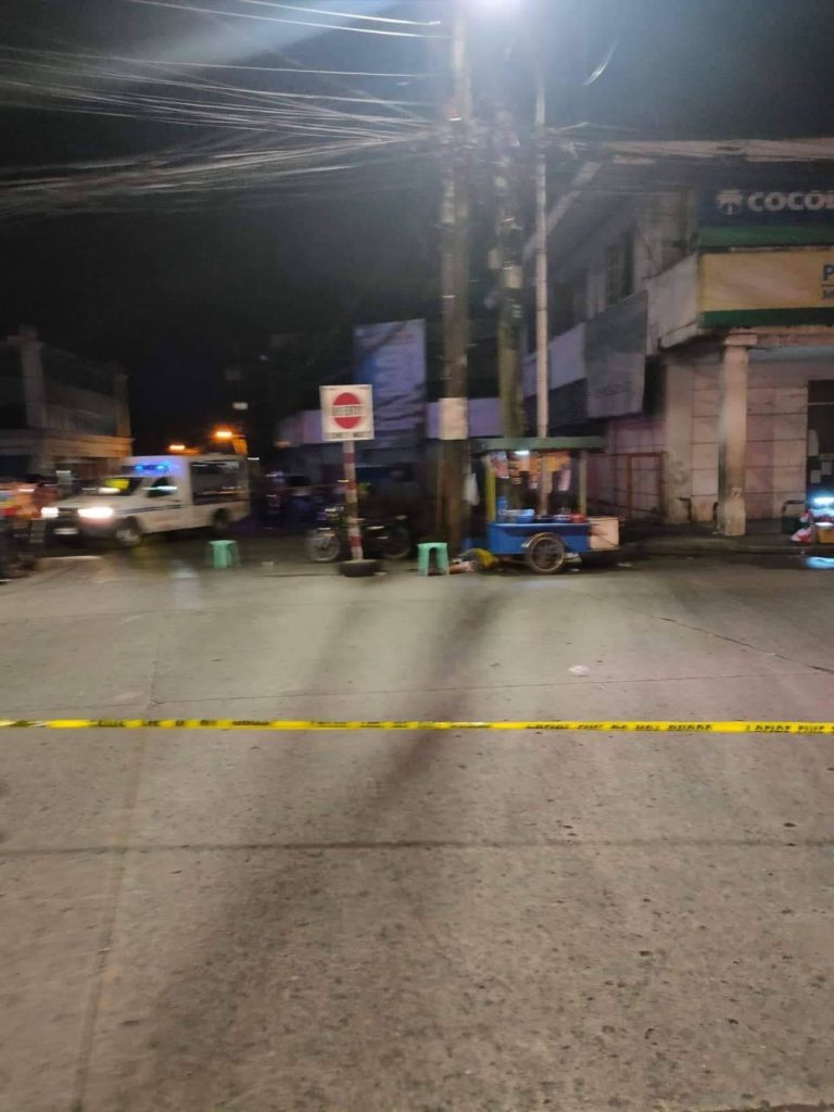 A photo released by the Bacolod City Police Office shows the body of Jestoni Sabare, lower right, at the intersection of San Juan and Luzuriaga Streets, one of the busy intersections during peak hours. Sabare was shot dead near a police station and the old City Hall. | Photo courtesy of Bacolod City Police Office