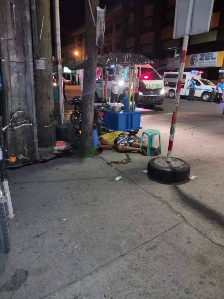A photo released by the Bacolod City Police Office shows the body of Jestoni Sabare, lower right, at the intersection of San Juan and Luzuriaga Streets, one of the busy intersections during peak hours. Sabare was shot dead near a police station and the old City Hall. | Photo courtesy of Bacolod City Police Office