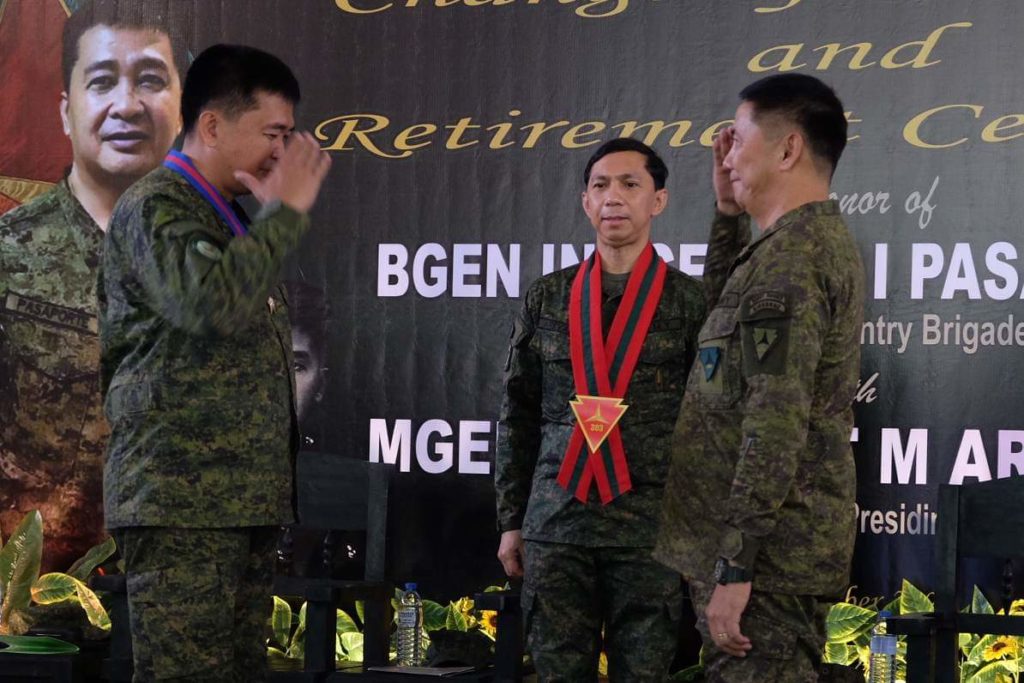 The Mistah Takes Over. Colonel Michael Samson salutes his former commander, Brigadier General Innocencio Pasaporte, as he officially becomes acting commander of the 303rd Infantry Brigade based In Negros Occidental province, Philippines. | Photo by Nikki Magbanua