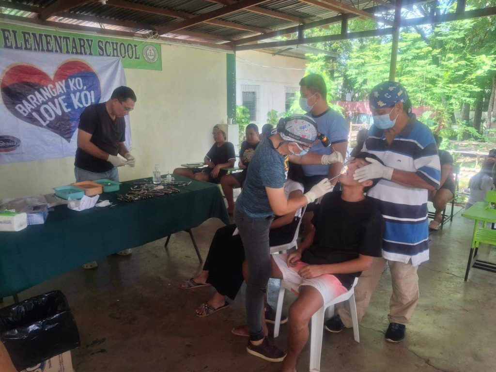 Dentists and other community volunteers help out in the dental mission.