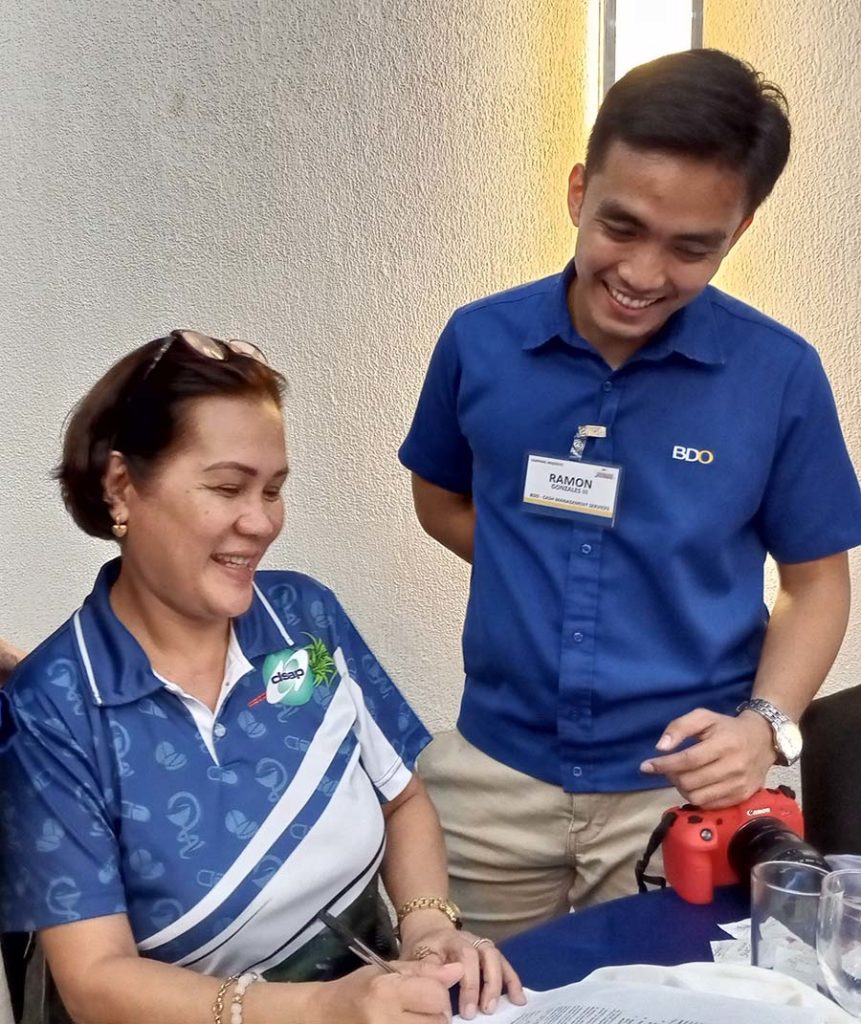 Anna Liza Santiago (left) shows appreciation on how BDO CMS will improve the check disbursement process of her pharmaceutical business, as explained by Ramon Gonzales III, Business Development Officer of BDO's CMS-SME.